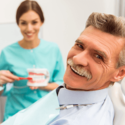 Man smiles in dentist's chair