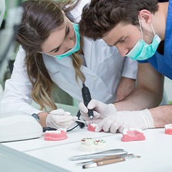 Technicians crafting dentures