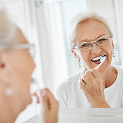 Lady brushes teeth