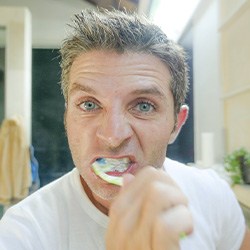 Man brushes teeth