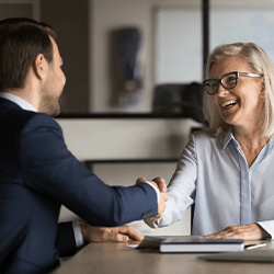 Two people shake hands at work