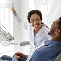 Patient talking to dentist about dental crowns in Garland