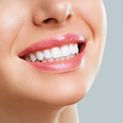 Nose-to-neck ¾ profile of woman smiling with bright teeth