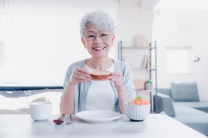 Woman with dentures getting ready to eat her favorite treat