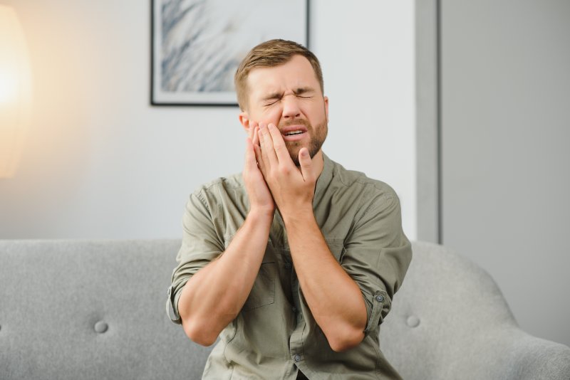 A man suffering from a cavity between his teeth